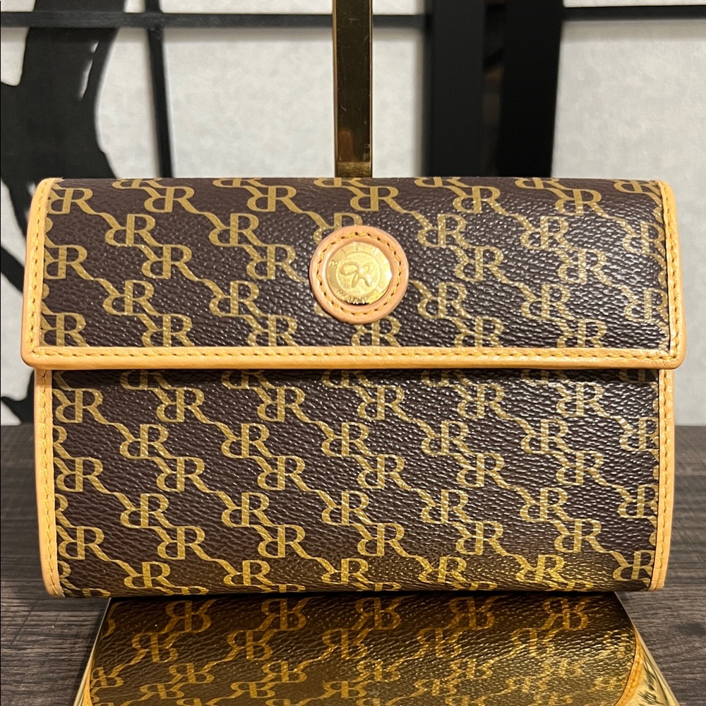 RIONI Vintage monogram clutch features a distinct brown and gold "RR"